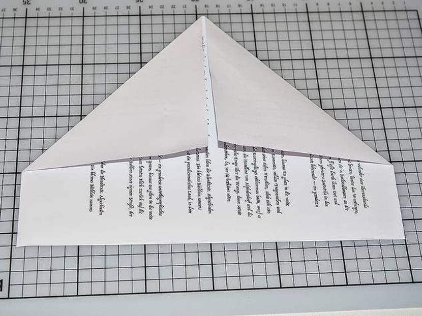 Legen Sie das Blatt quer vor sich hin und falten Sie die oberen Ecken nach innen.