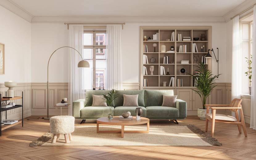 Ein Wohnzimmer ist mit hellen Holzmöbeln und Parkett sowie einer grünen Couch ausgestattet. 