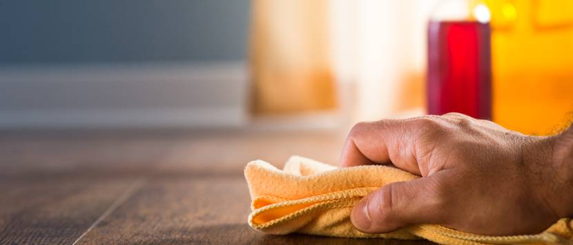 hand mit putzlappen auf parkett