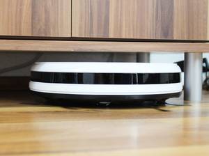Flacher Saugroboter unterm Schrank