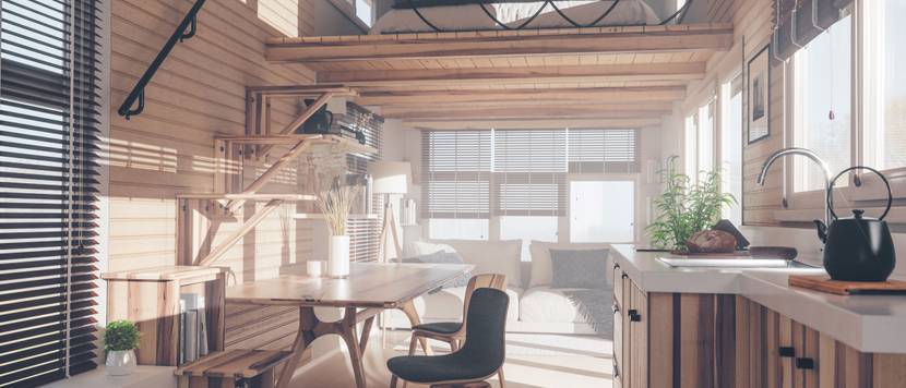 Wohnraum eines Tiny house mit Schlafraum in einer oberen, offenen Etage.